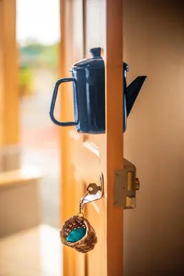 a door latch with a snake attached to it at Coffee Pickers Village By Hacienda Orosi in Cartago