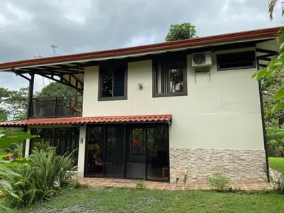 a house with a dog standing in front of it at Serenity in Fortuna
