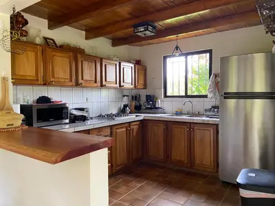 a kitchen with wooden cabinets and a stainless steel refrigerator at Serenity in Fortuna