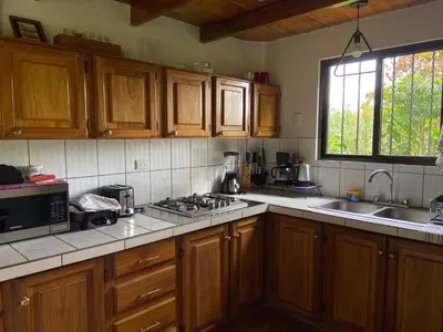 a kitchen with wooden cabinets and a stove top oven at Serenity in Fortuna