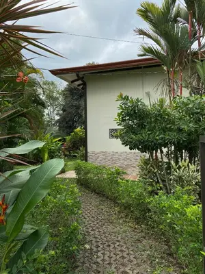 a path in front of a white building with trees at Serenity in Fortuna