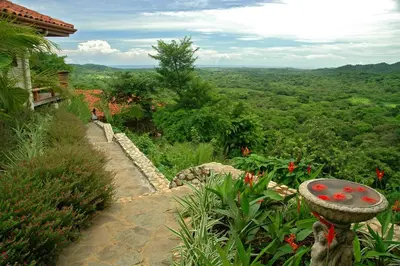 a stone path leading up to a house with a view at Los Altos de Eros - Adults Only in Playa Avellana