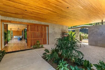 a home with a wooden ceiling and a patio at The L Design Villa in Carmen