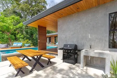 a patio with a picnic table and a grill at The L Design Villa in Carmen