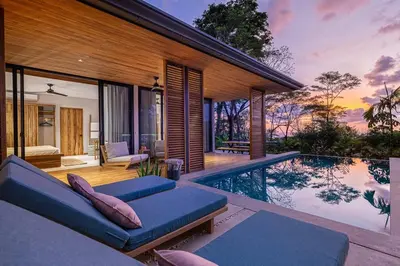 a villa with a swimming pool and a house at The L Design Villa in Carmen
