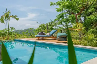 a swimming pool with two lounge chairs next to a pool at The L Design Villa in Carmen