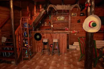 a room with a bar in a wooden cabin at Cabaña Ave Del Paraiso in Cartago