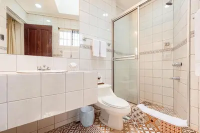 a bathroom with a toilet and a shower and a sink at Posada el Quijote in San José