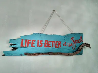 a sign that says life is better of us at Tortuguero Adventures Beach House in Tortuguero