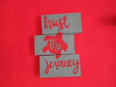 a wooden sign with the words trust the journey at Tortuguero Adventures Beach House in Tortuguero