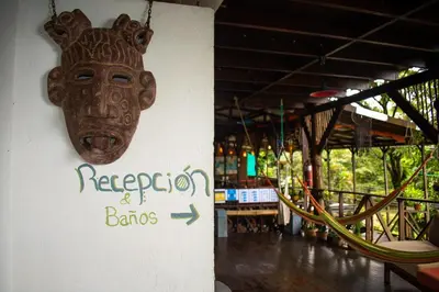 a mask hanging on the side of a building at Hostel Plinio in Manuel Antonio