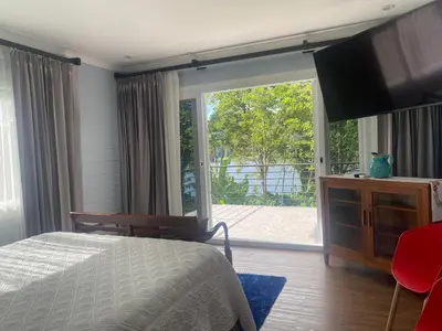 a bedroom with a bed and a large sliding glass door at CASA DEL LAGO in Cachí