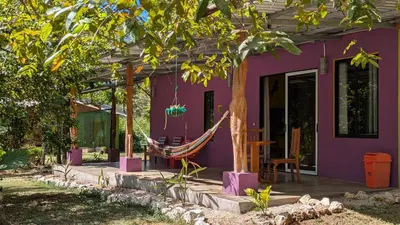 a purple house with a hammock in front of it at Casa Coco Playa Marbella with AC, Swimming Pool, Skate Bowl & walking distance Beach for Surfers and Nature Lovers in Marbella