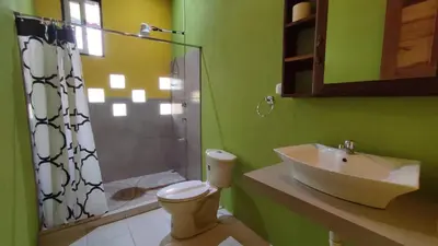 a bathroom with a sink and a toilet and a shower at Casa Coco Playa Marbella with AC, Swimming Pool, Skate Bowl & walking distance Beach for Surfers and Nature Lovers in Marbella