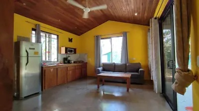 a living room with a couch and a refrigerator at Casa Coco Playa Marbella with AC, Swimming Pool, Skate Bowl & walking distance Beach for Surfers and Nature Lovers in Marbella