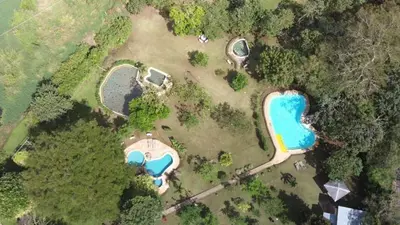 an overhead view of a park with two ponds at Colinas del Miravalles Hotel & Hot Springs in Hacienda Guayabo