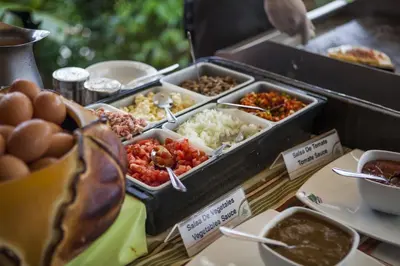 a buffet with different types of food on a table at Hotel Arenal Springs Resort & Spa in Fortuna