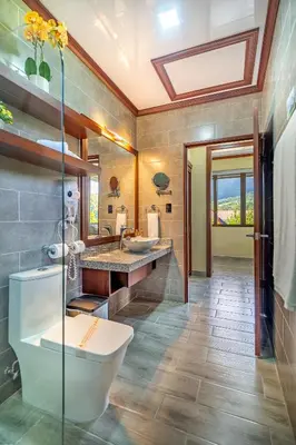 a bathroom with two sinks and a tub at Hotel Arenal Springs Resort & Spa in Fortuna