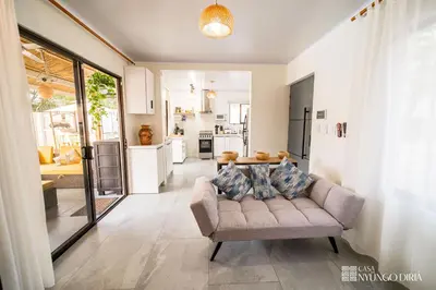 a living room with a couch and a kitchen at Bungalow with private pool only 15min from Tamarindo Beach in Tamarindo