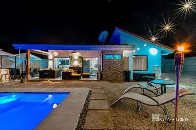 a villa with a swimming pool at night at Bungalow with private pool only 15min from Tamarindo Beach in Tamarindo