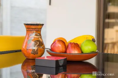 a bowl of fruit and a vase on a table at Bungalow with private pool only 15min from Tamarindo Beach in Tamarindo