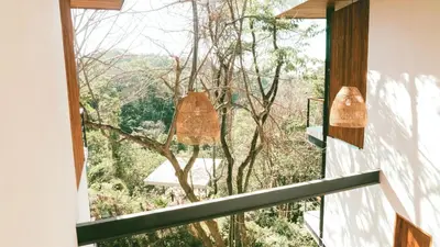 a room with a window with a view of the forest at Villa Gaspar Terrazas in Playa hermosa