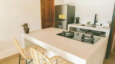 a kitchen with a counter with a stove and a sink at Villa Gaspar Terrazas in Playa hermosa