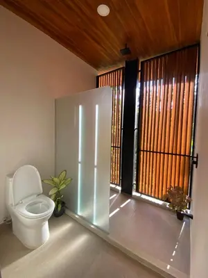a bathroom with a toilet and a window at Villa Gaspar Terrazas in Playa hermosa