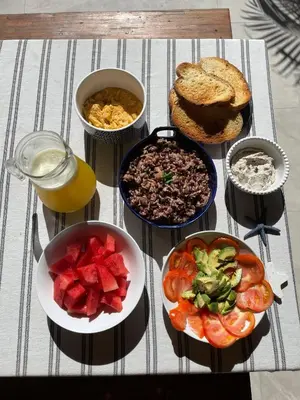 a table topped with bowls of food and bread at Villa Gaspar Terrazas in Playa hermosa