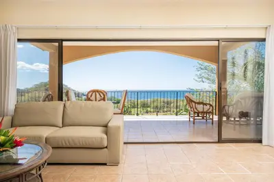 a living room with a couch and a view of the ocean at Vida de la Paz 4 - Oceanview Condo, 2BR, just remodeled, Playa Prieta in Potrero