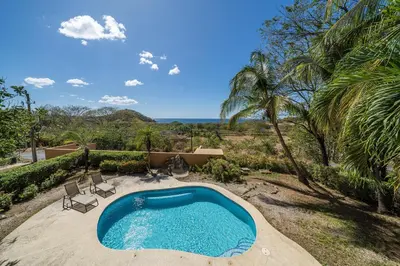 a swimming pool in the backyard of a house at Vida de la Paz 4 - Oceanview Condo, 2BR, just remodeled, Playa Prieta in Potrero