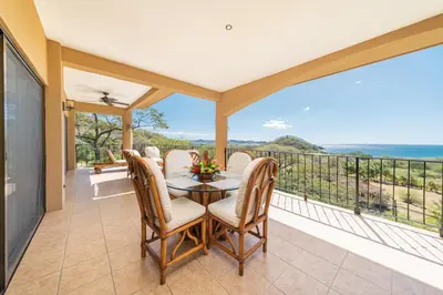 a dining room with a table and chairs on a balcony at Vida de la Paz 4 - Oceanview Condo, 2BR, just remodeled, Playa Prieta in Potrero