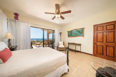 a bedroom with a bed and a ceiling fan at Vida de la Paz 4 - Oceanview Condo, 2BR, just remodeled, Playa Prieta in Potrero