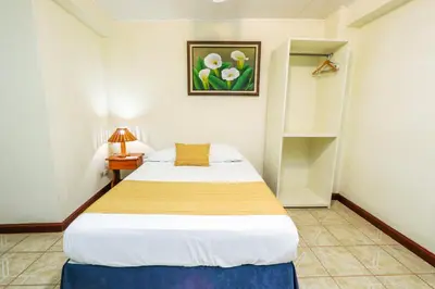 a bedroom with a bed in a small room at Hotel Flor Blanca in Manuel Antonio