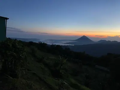 a view of a mountain with the sunset in the background at Vistaverde Lodge in Monteverde Costa Rica