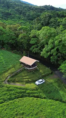 a car parked in front of a house in a field at Cabaña Montaña de Sueños in Quesada