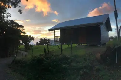 a small building with a roof in a field at Cabaña Montaña de Sueños in Quesada