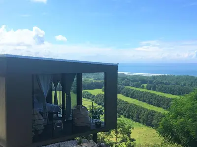a black house with a view of the ocean at La Colina Pura Vista in Bejuco