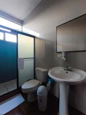 a bathroom with a sink and a toilet at Hotel Cielo Azul Resort in Tilarán