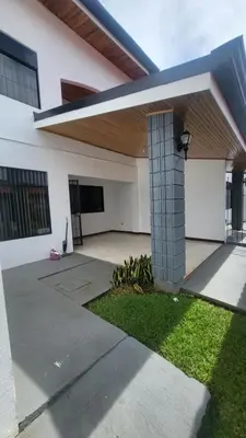 a white house with at Don Carlos Place LOWER UNIT in Alajuela City