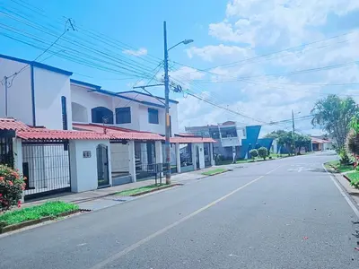 an empty street in a town with houses at Don Carlos Place LOWER UNIT in Alajuela City