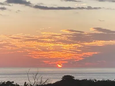 a sunset over the ocean with the sun in the sky at Pacific View Condominium in Playa Azul in Playa Azul