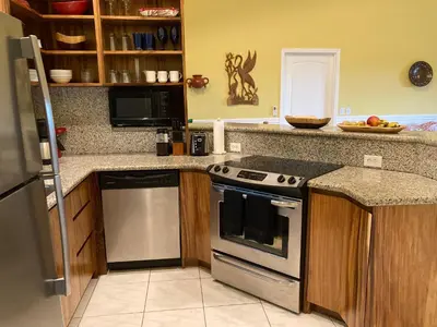 a kitchen with a stove and a counter top at Pacific View Condominium in Playa Azul in Playa Azul
