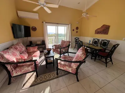 a living room filled with furniture and a flat screen tv at Pacific View Condominium in Playa Azul in Playa Azul