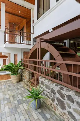 a building with a spiral staircase in a courtyard at Hotel Ribera La Paz in San Ramón