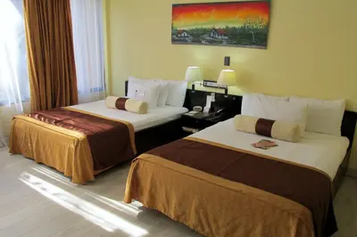 a hotel room with two beds in a room at Best Western El Sitio Hotel in Liberia