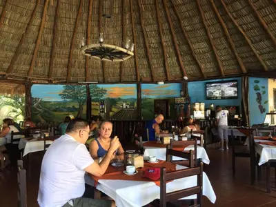 a man and woman sitting at a table in a restaurant at Best Western El Sitio Hotel in Liberia