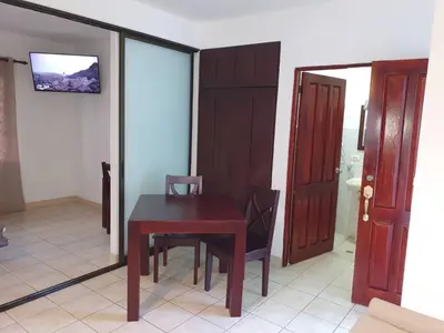 a table and chair in a room with a mirror at Apart Hotel Marina Loft 214 in Coco