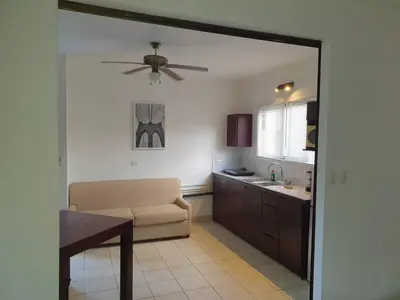 a living room with a couch and a ceiling fan at Apart Hotel Marina Loft 214 in Coco