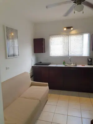 a living room with a couch and a kitchen at Apart Hotel Marina Loft 214 in Coco